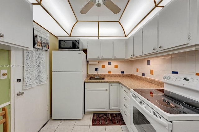 kitchen with white appliances, white cabinets, sink, ceiling fan, and light tile patterned floors