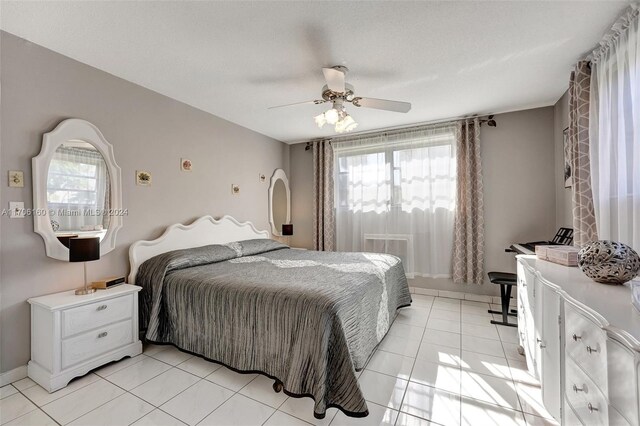 tiled bedroom with ceiling fan