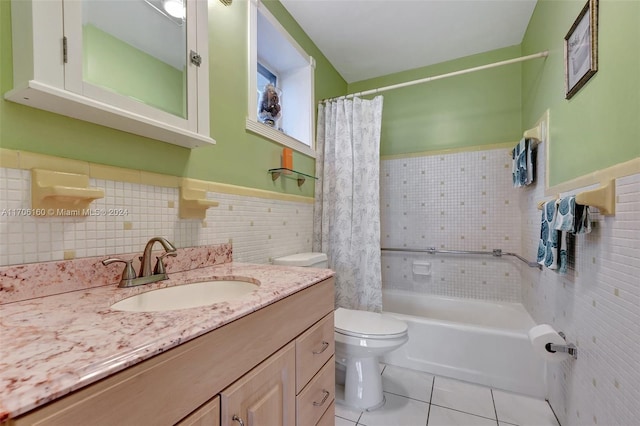 full bathroom featuring vanity, tile patterned flooring, toilet, shower / bath combo with shower curtain, and tile walls