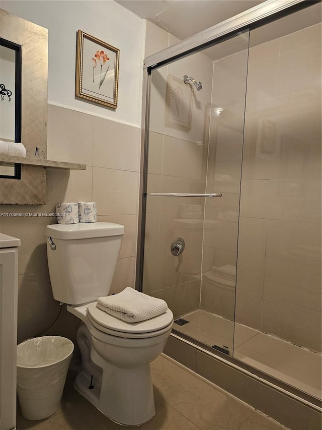 bathroom featuring tile patterned floors, tile walls, an enclosed shower, and toilet