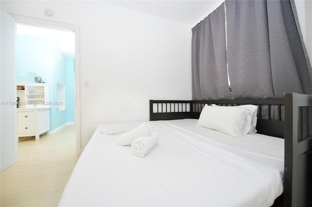 bedroom with light wood-type flooring