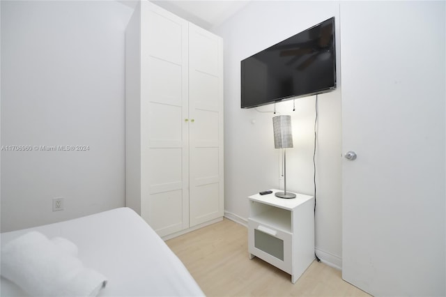 bedroom with light hardwood / wood-style flooring and a closet