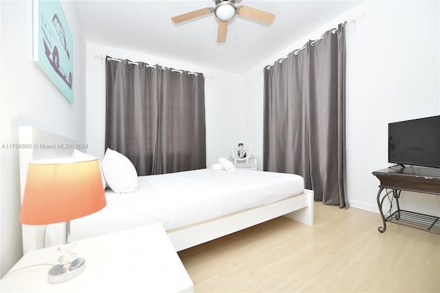 bedroom with ceiling fan and light hardwood / wood-style floors