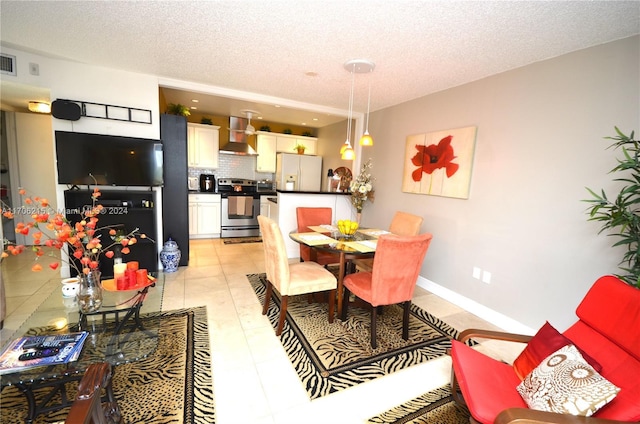 dining space with light tile patterned flooring and a textured ceiling