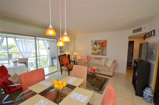 tiled dining space featuring a textured ceiling