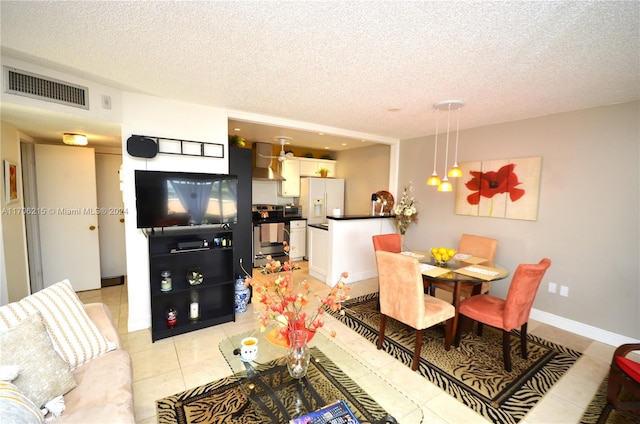 dining room with light tile patterned floors and a textured ceiling