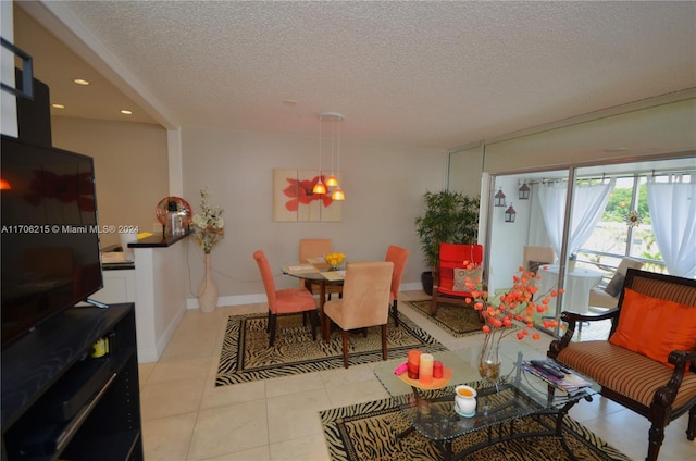 tiled dining room with a textured ceiling