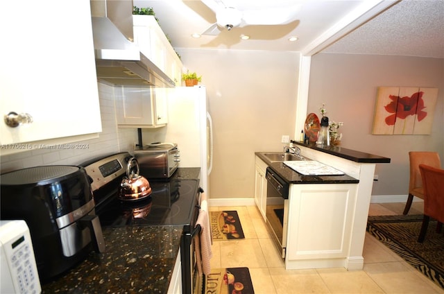 kitchen with white cabinets, electric range, sink, and wall chimney range hood