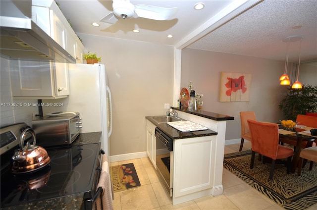 kitchen featuring black dishwasher, white cabinets, wall chimney range hood, and stainless steel range with electric cooktop