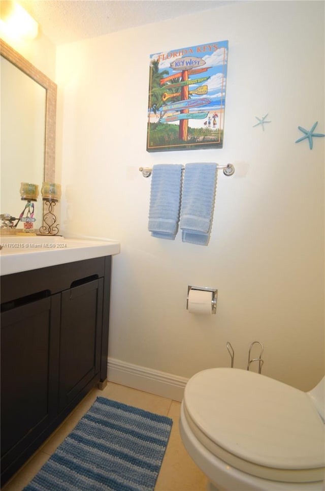 bathroom with tile patterned floors, vanity, and toilet