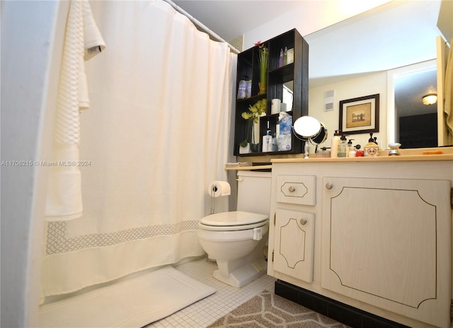 bathroom with tile patterned flooring, vanity, and toilet