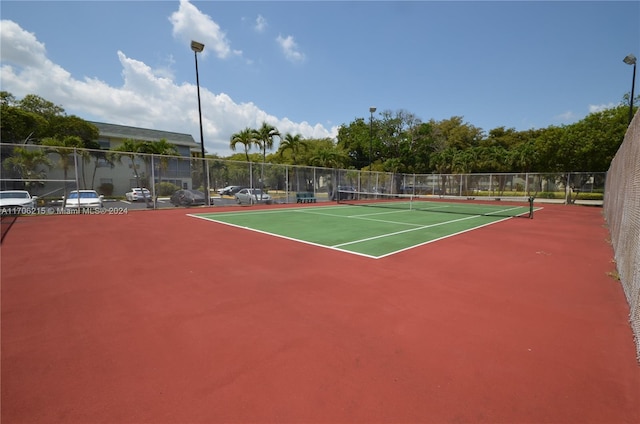 view of tennis court featuring basketball hoop