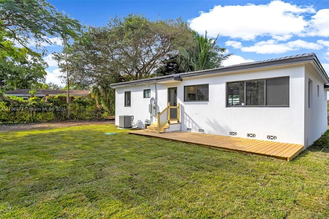 back of property featuring a yard and central air condition unit