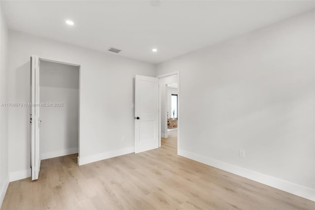 unfurnished bedroom featuring a closet and light hardwood / wood-style flooring