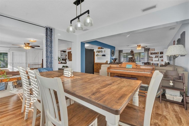 dining area featuring ceiling fan, light hardwood / wood-style flooring, and a healthy amount of sunlight