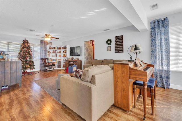 living room with ceiling fan and light hardwood / wood-style floors