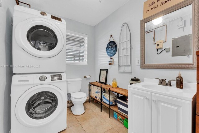 bathroom with tile patterned floors, vanity, stacked washer and clothes dryer, electric panel, and toilet