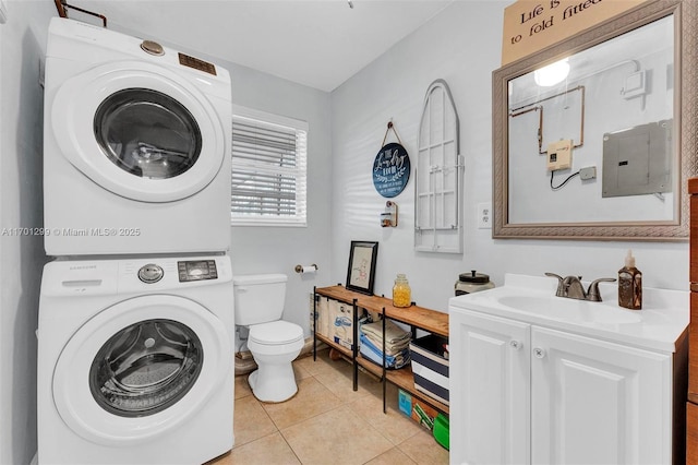 laundry area with electric panel, light tile patterned flooring, sink, and stacked washer and clothes dryer