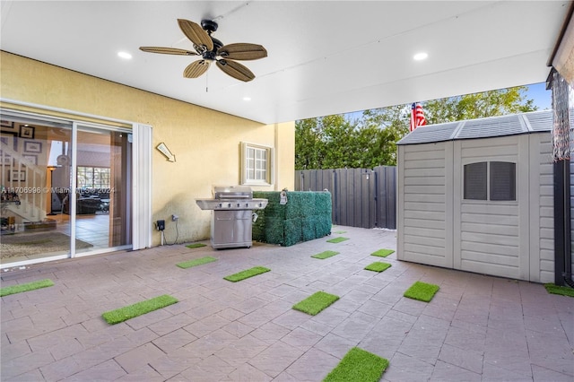 view of patio / terrace with a storage unit, ceiling fan, and grilling area