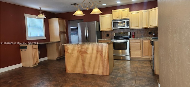 kitchen featuring a center island, hanging light fixtures, light stone countertops, tasteful backsplash, and stainless steel appliances