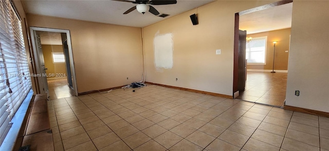 unfurnished room with ceiling fan and light tile patterned floors