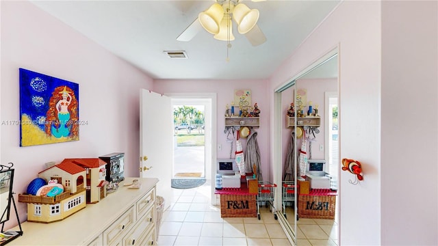 interior space featuring ceiling fan and light tile patterned floors