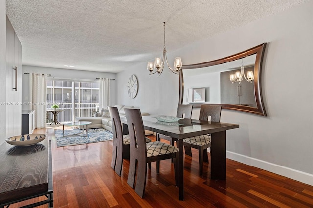 dining space featuring a chandelier, a textured ceiling, and hardwood / wood-style flooring