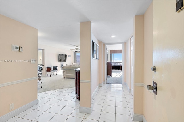 5 Bluebill Unit 701, Naples, FL 34108 - hall with light carpet, baseboards, and light tile patterned floors