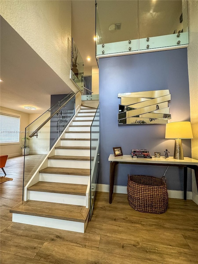 stairs with hardwood / wood-style floors