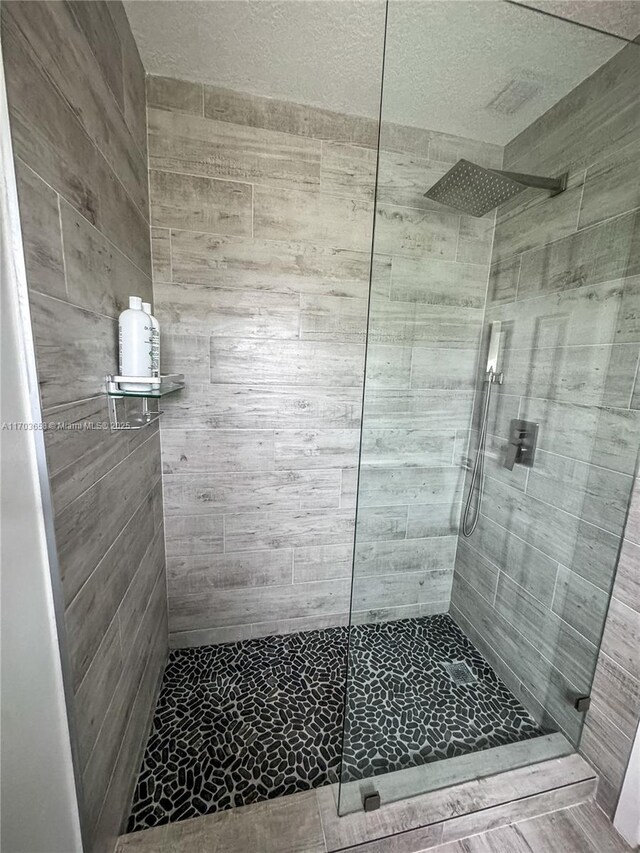 bathroom with a tile shower