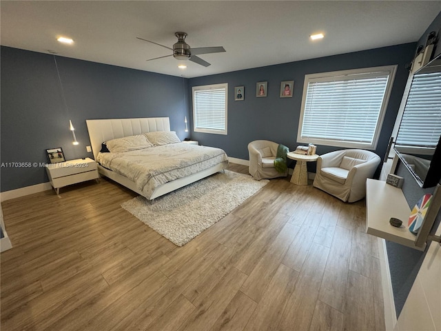 bedroom with hardwood / wood-style floors and ceiling fan