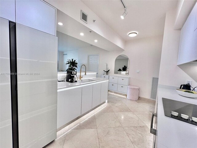 1755 E Hallandale Beach Blvd Unit 405E, Hallandale Beach, FL 33009 - kitchen featuring modern cabinets, white cabinets, light marble finish floors, light countertops, and recessed lighting