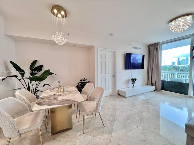 dining room with an inviting chandelier and a wall of windows