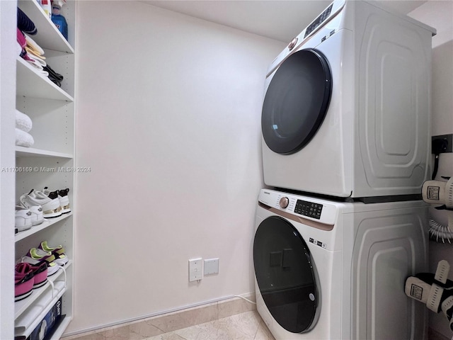 1755 E Hallandale Beach Blvd Unit 405E, Hallandale Beach, FL 33009 - washroom with stacked washer / dryer and light tile patterned floors