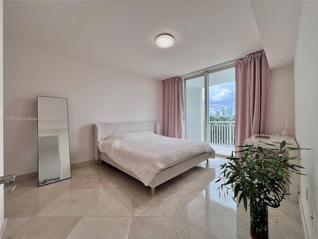 1755 E Hallandale Beach Blvd Unit 405E, Hallandale Beach, FL 33009 - bedroom with access to exterior, expansive windows, and light marble finish flooring