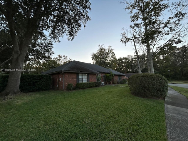 view of property exterior with a lawn