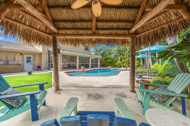 view of swimming pool with a gazebo, exterior kitchen, and a patio