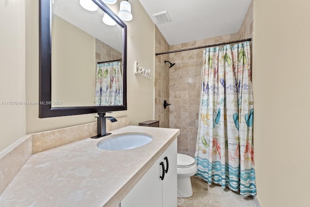 bathroom featuring tile patterned floors, curtained shower, vanity, and toilet