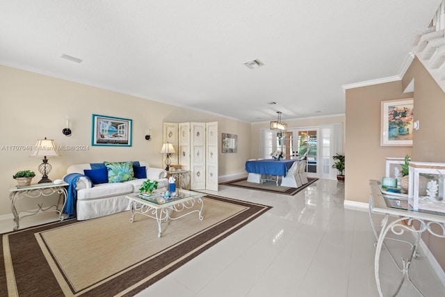 tiled living room with crown molding and french doors