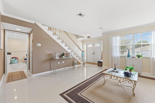 entryway featuring a textured ceiling, light tile patterned floors, and crown molding