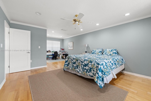 bedroom featuring ceiling fan, hardwood / wood-style floors, and crown molding