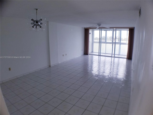 unfurnished room with ceiling fan and light tile patterned flooring