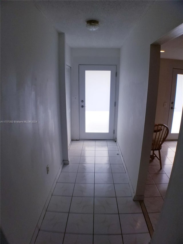 hall with a textured ceiling