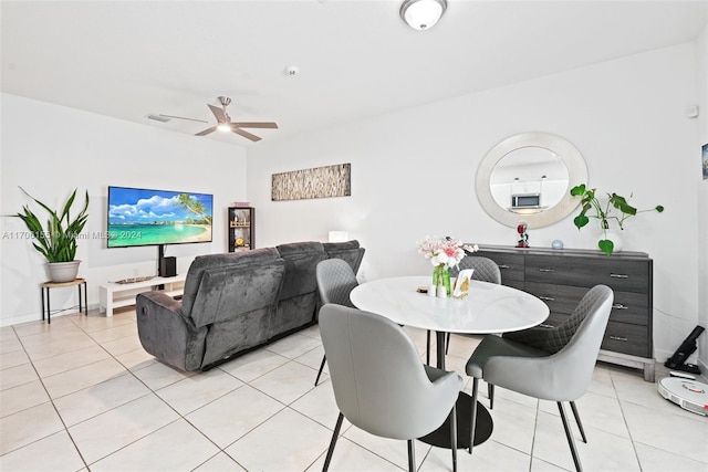 dining room with ceiling fan and light tile patterned flooring