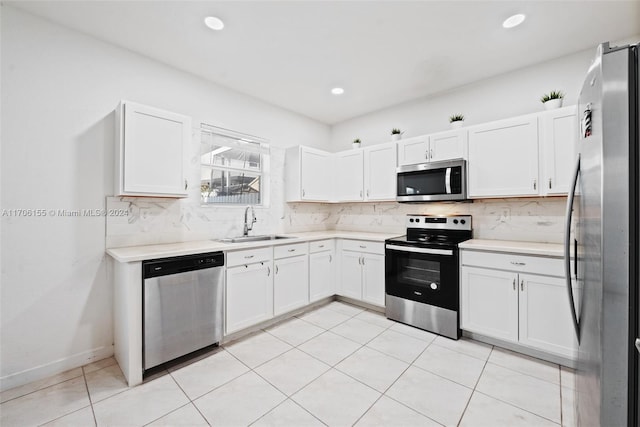 kitchen featuring backsplash, sink, white cabinets, and appliances with stainless steel finishes