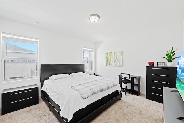 bedroom featuring light carpet