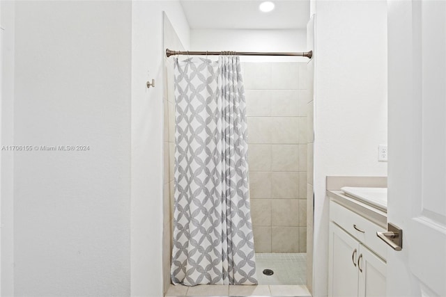 bathroom with curtained shower and vanity