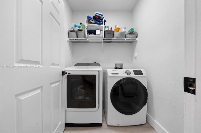 clothes washing area featuring washer and dryer