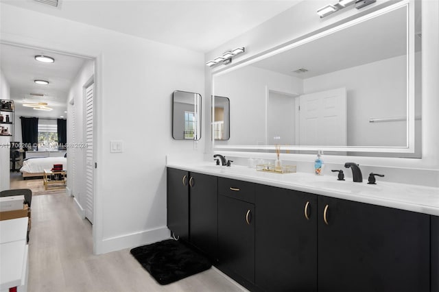 bathroom with hardwood / wood-style flooring and vanity