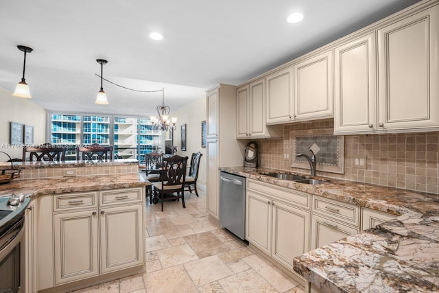 kitchen featuring cream cabinets, appliances with stainless steel finishes, pendant lighting, and sink